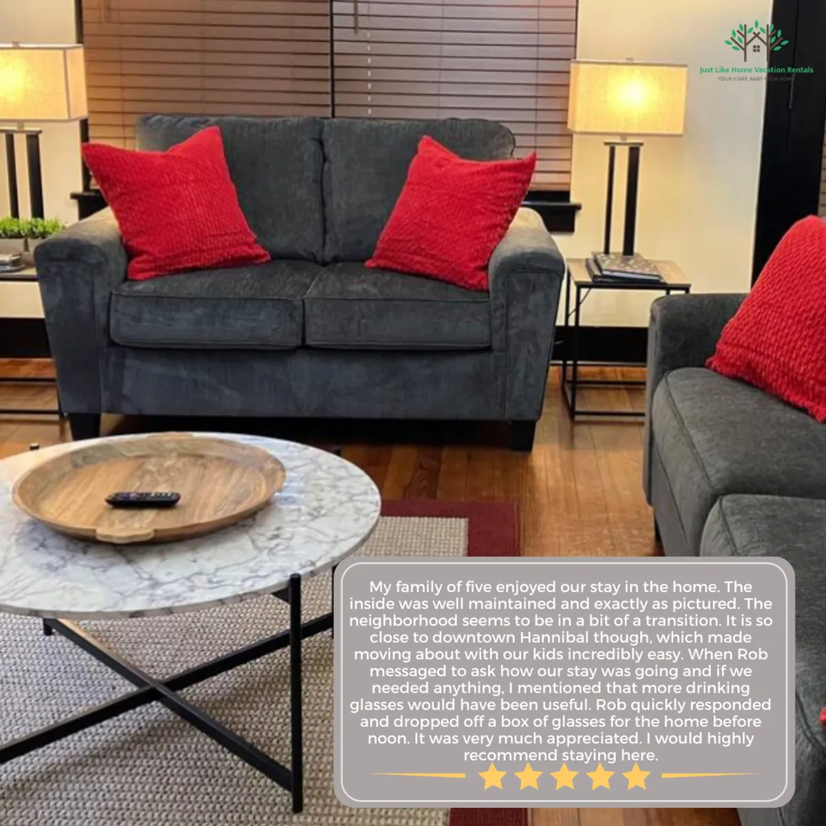 This image features a comfortable living room with a plush sofa adorned with red throw pillows, a coffee table, and a cozy lamp. The inviting arrangement suggests a space perfect for relaxing, watching TV, or gathering with family and friends, showcasing the room’s welcoming atmosphere and freshly updated look.